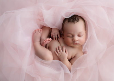 Newborn baby Girl on Pink Material